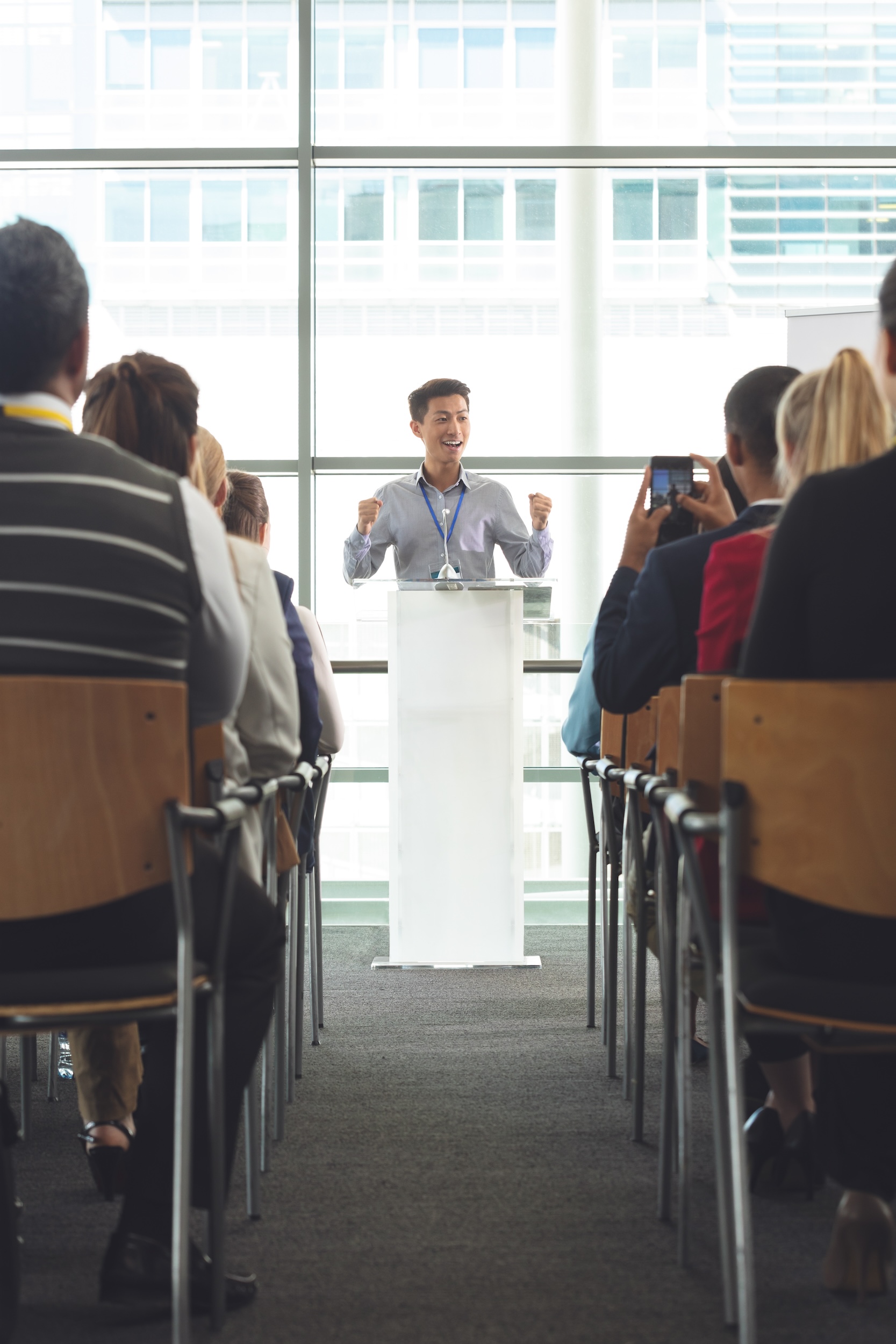 Businessman speaks excitedly in a conference hall
