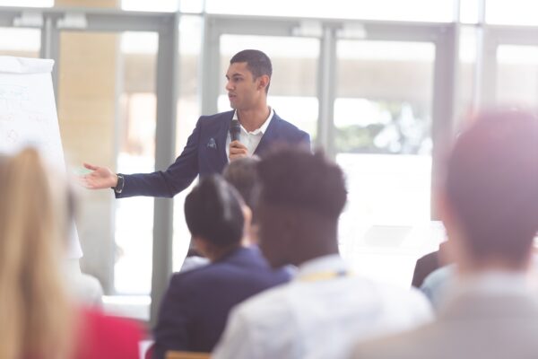 Confident man speaks to an audience | Palisade Clinical Trials